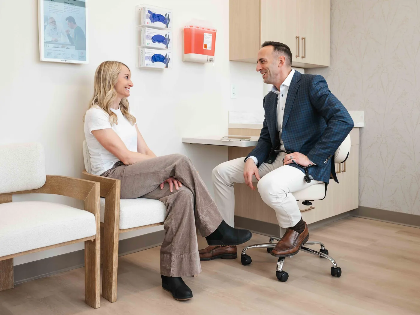 Dr. Sean Stanga talking with a patient in a consulting room at the West Des Moines clinic