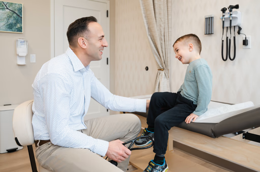 Dr. Sean Stanga talking with a young patient during an exam